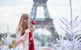 Paris, Mädchen mit kandiertem Apfel und im Hintergrund der Eifelturm